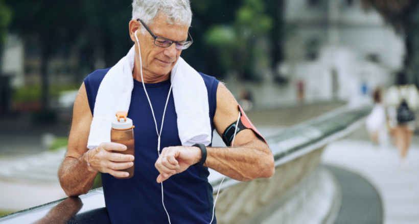 A senior man checking his smartwatch after a workout, illustrating active aging with Iollo.