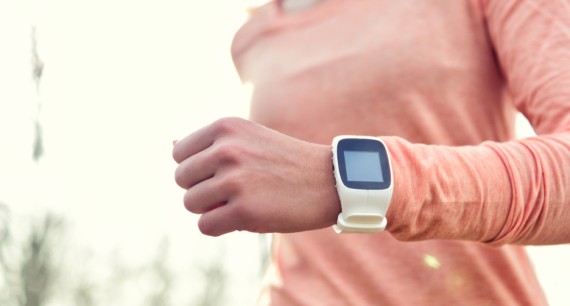 Person exercising wearing a wearable to track health.