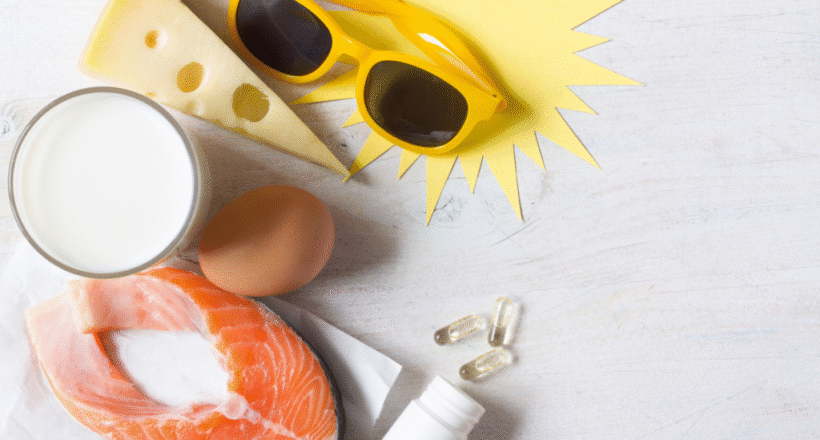 Salmon, milk, eggs, cheese and sunglasses arranged with vitamin D capsules.