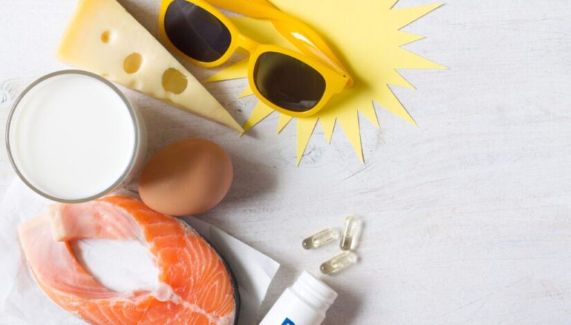 Salmon, milk, eggs, cheese and sunglasses arranged with vitamin D capsules.